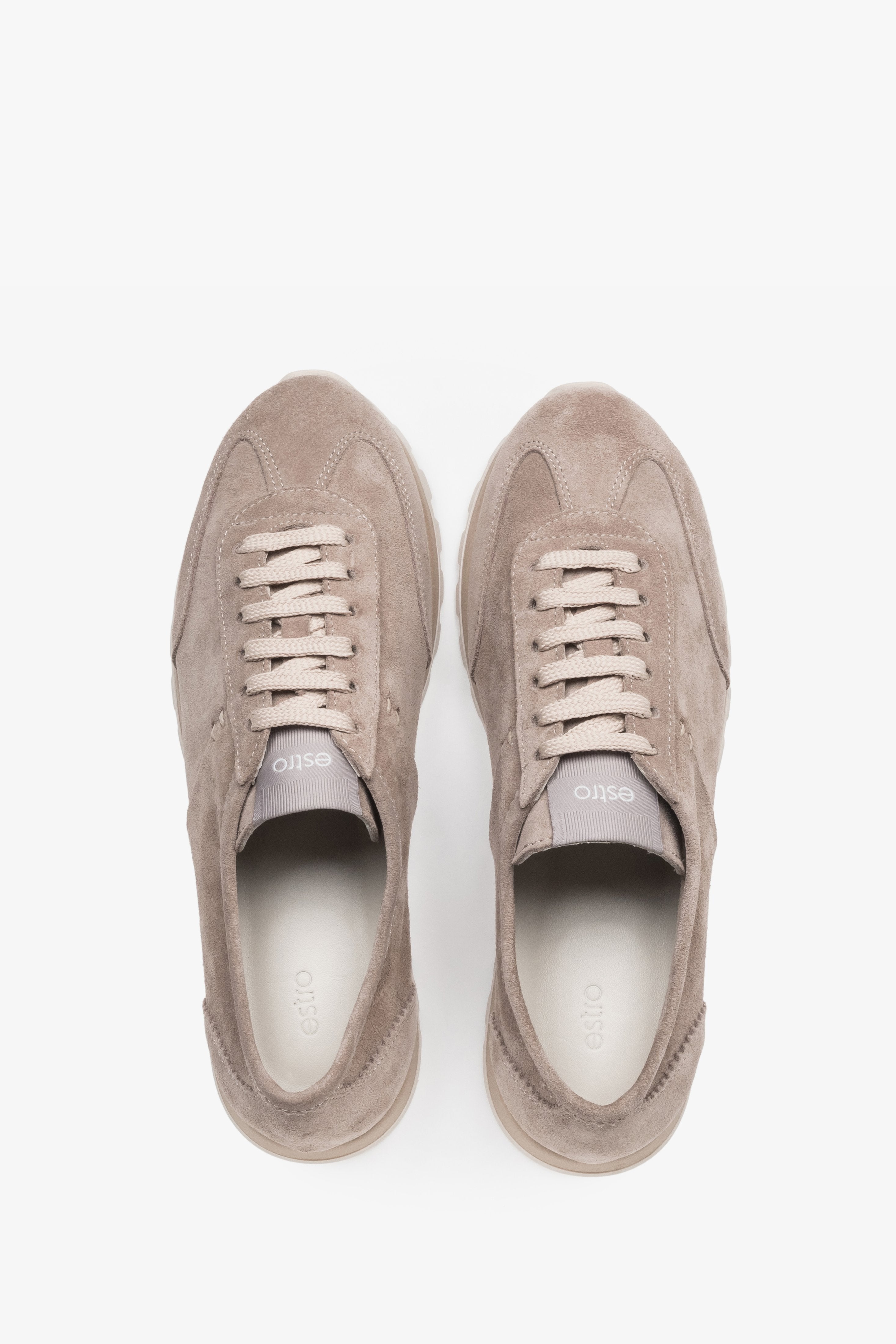 Light beige natural velour trainers featuring perforated details and a white sole.