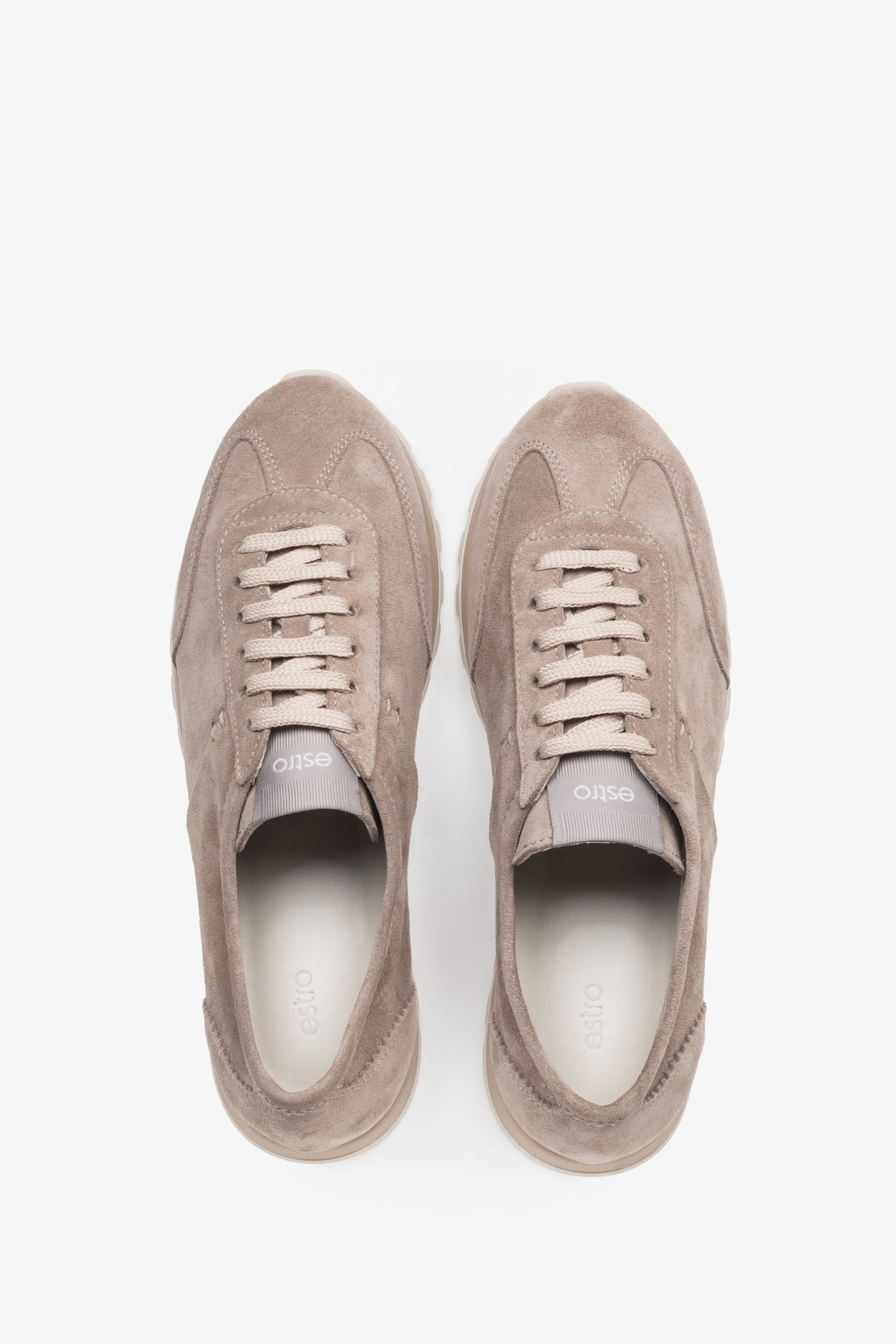 Light beige natural velour trainers featuring perforated details and a white sole.