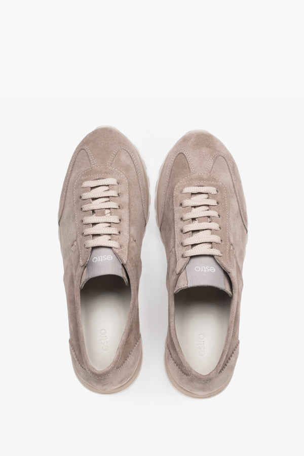 Light beige natural velour trainers featuring perforated details and a white sole.