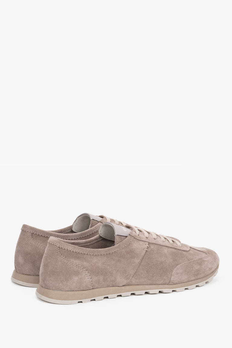 Close-up of the soft velour texture and reinforced heel on beige women's sneakers.