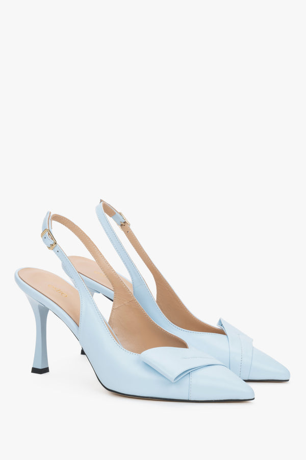 Light blue leather Estro slingback pumps on a high stiletto heel, featuring a deep vamp, a geometric toe embellishment, and a delicate heel strap.