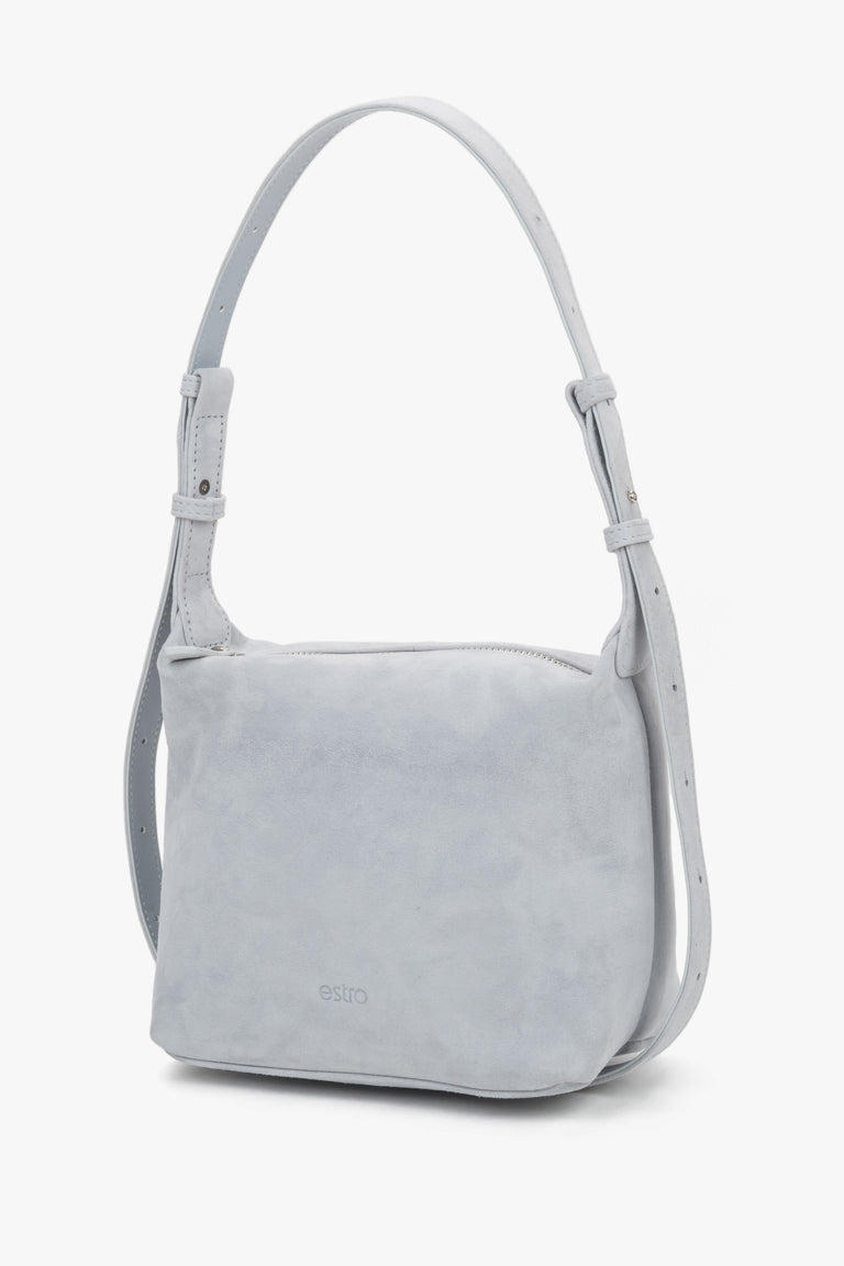 Estro light blue suede women's shoulder bag, showcasing a minimalist front with a subtle brand logo and a soft, structured silhouette.