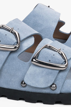 Light blue women’s natural velour slides with a silver buckle and studs – detail close-up.