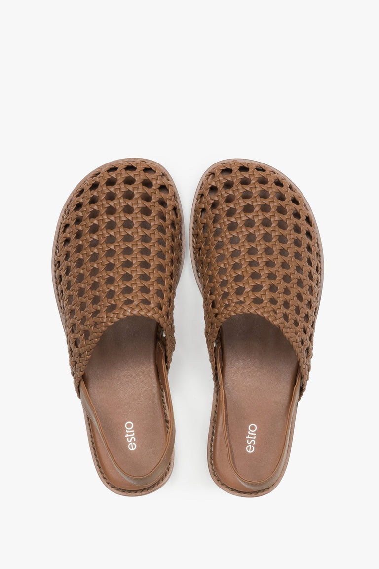 Women's flat leather sandals with an intricate openwork weave.