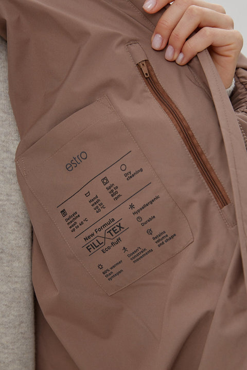 Close-up of the lining of the women's light brown oversized quilted puffer jacket with high collar Estro ER00113903.