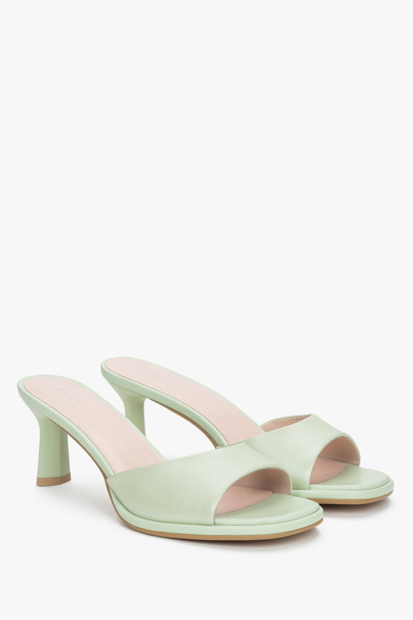 Light green women’s heeled leather mules.