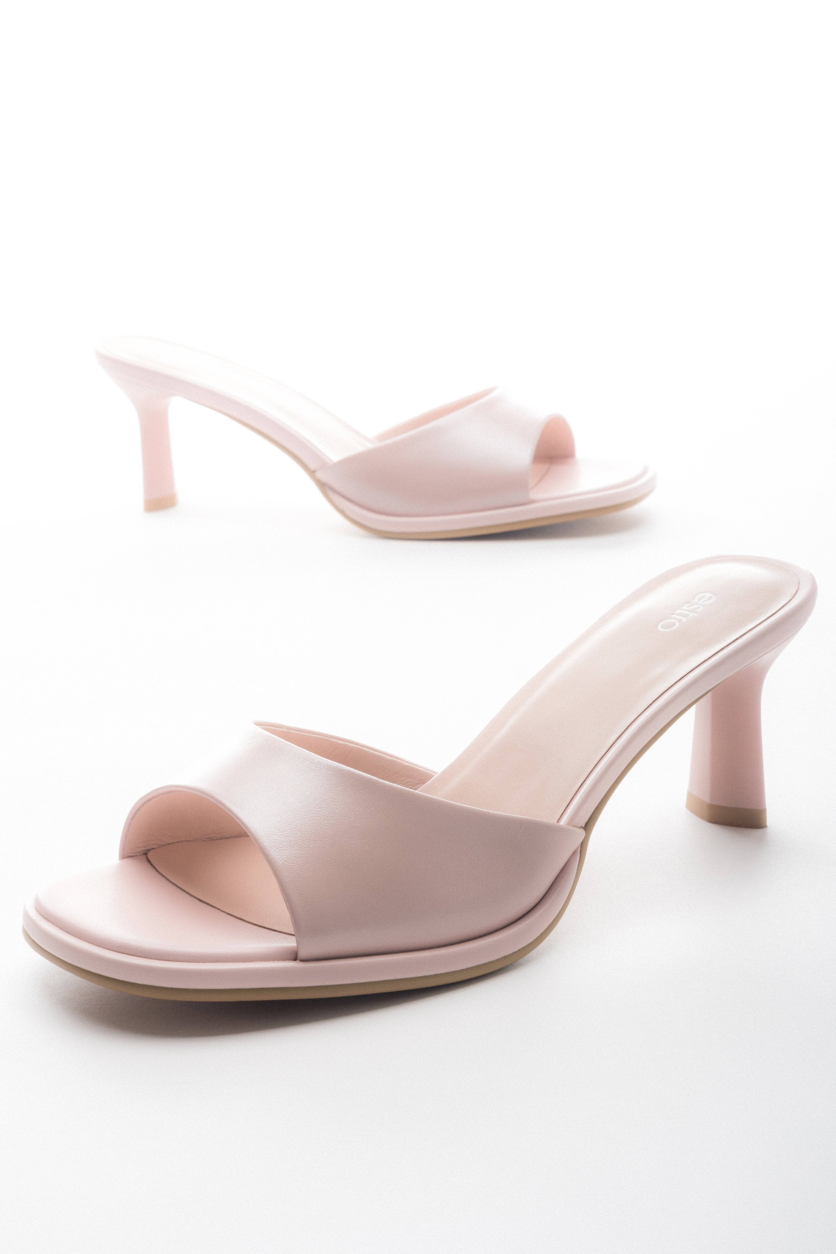 Light pink heeled mules made of genuine leather.