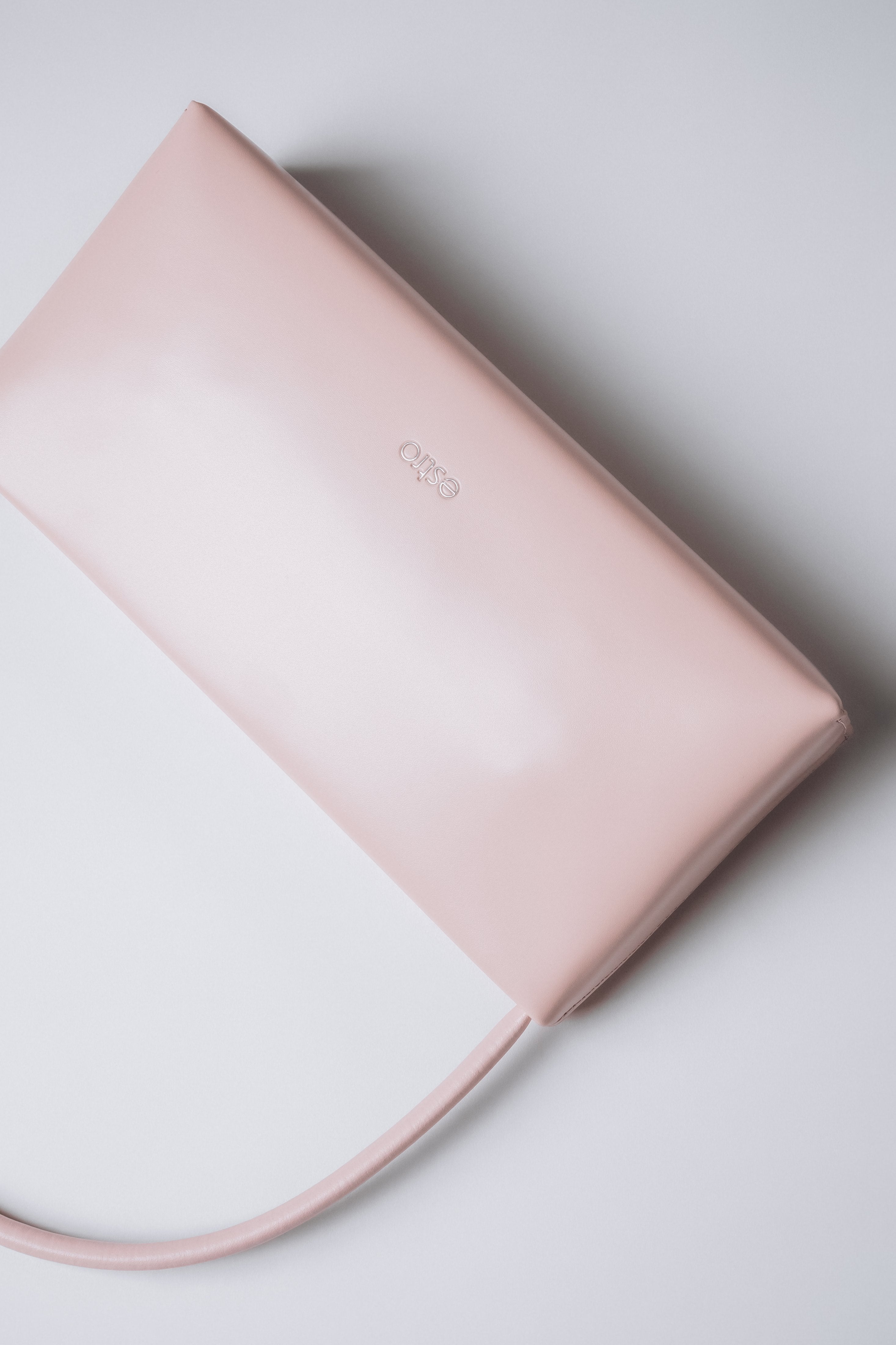 Light pink leather-blend handbag with polished silver-tone hardware.