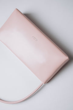 Light pink leather-blend handbag with polished silver-tone hardware.