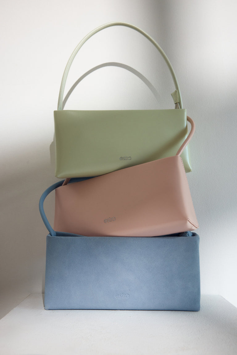 Chic light pink baguette bag with a sleek leather finish and silver zip.