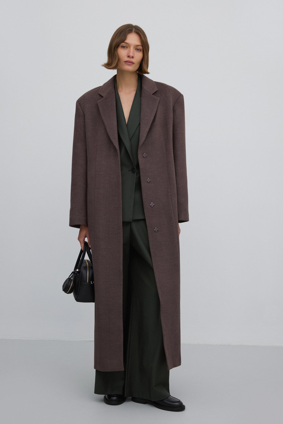 Long brown women’s coat, classic cut, belted.