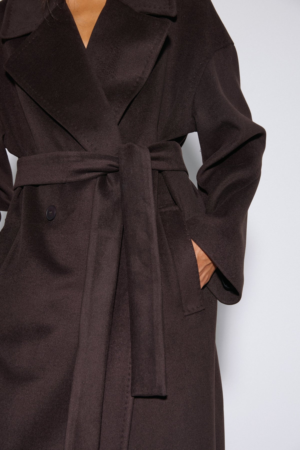 Women's dark brown wool coat Estro - close-up view highlighting the rich natural wool texture and lapel stitching.