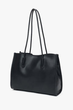 Black leather shopper bag by Estro with long handles, comfortable for everyday shoulder wear.