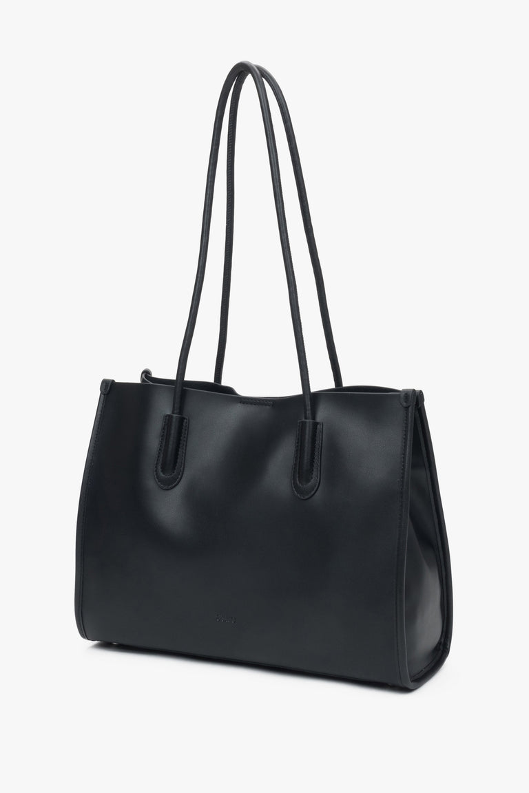 Black leather shopper bag by Estro with long handles, comfortable for everyday shoulder wear.
