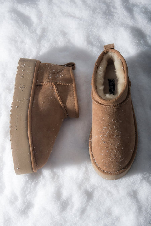 Low beige women's snow boots made of genuine velour with fur.