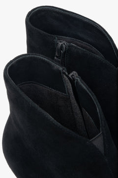 Low, black women’s ankle boots made of genuine velour with a funnel heel.