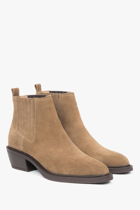 Brown cowboy ankle boots with a pointed toe and low heel, crafted from soft velour leather.