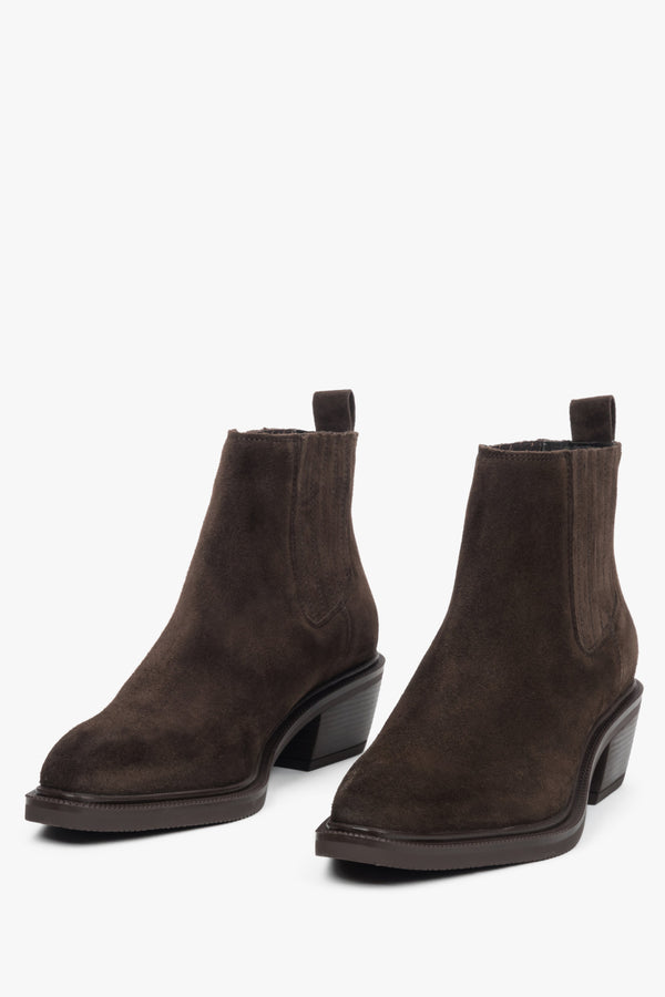 Dark brown cowboy ankle boots with a slanted heel and pointed toe, crafted from soft velour.