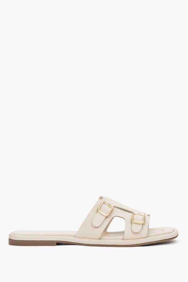 Women's beige genuine leather slide sandals with large, decorative gold buckles Estro, displaying a clean, elegant summer design.