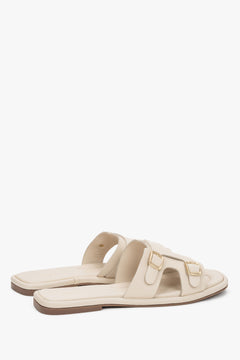 The back of the shoe showing the clean cuts, minimalist silhouette, and stable sole construction of the luxury slide sandals.