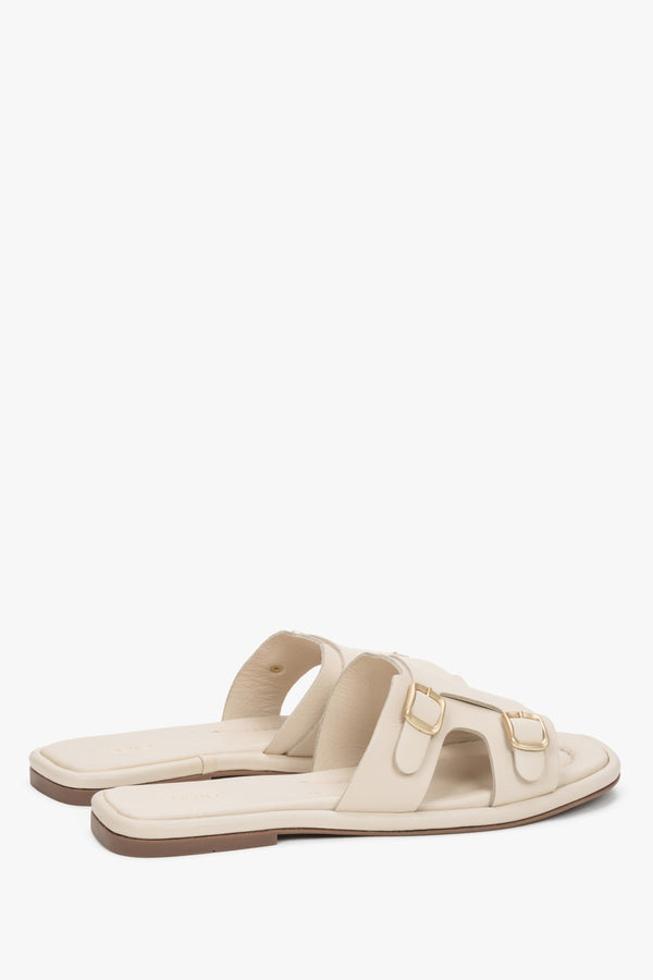 The back of the shoe showing the clean cuts, minimalist silhouette, and stable sole construction of the luxury slide sandals.