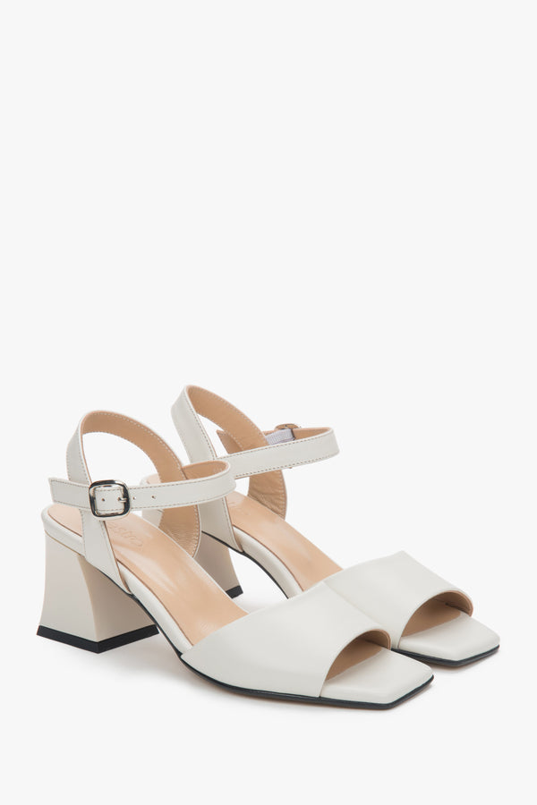 Milk-beige leather block-heel sandals with an adjustable buckle.