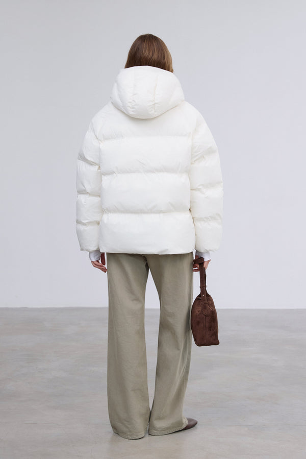 Stylish women's loose-fit jacket with eco-friendly filling in a milky beige shade by Estro.