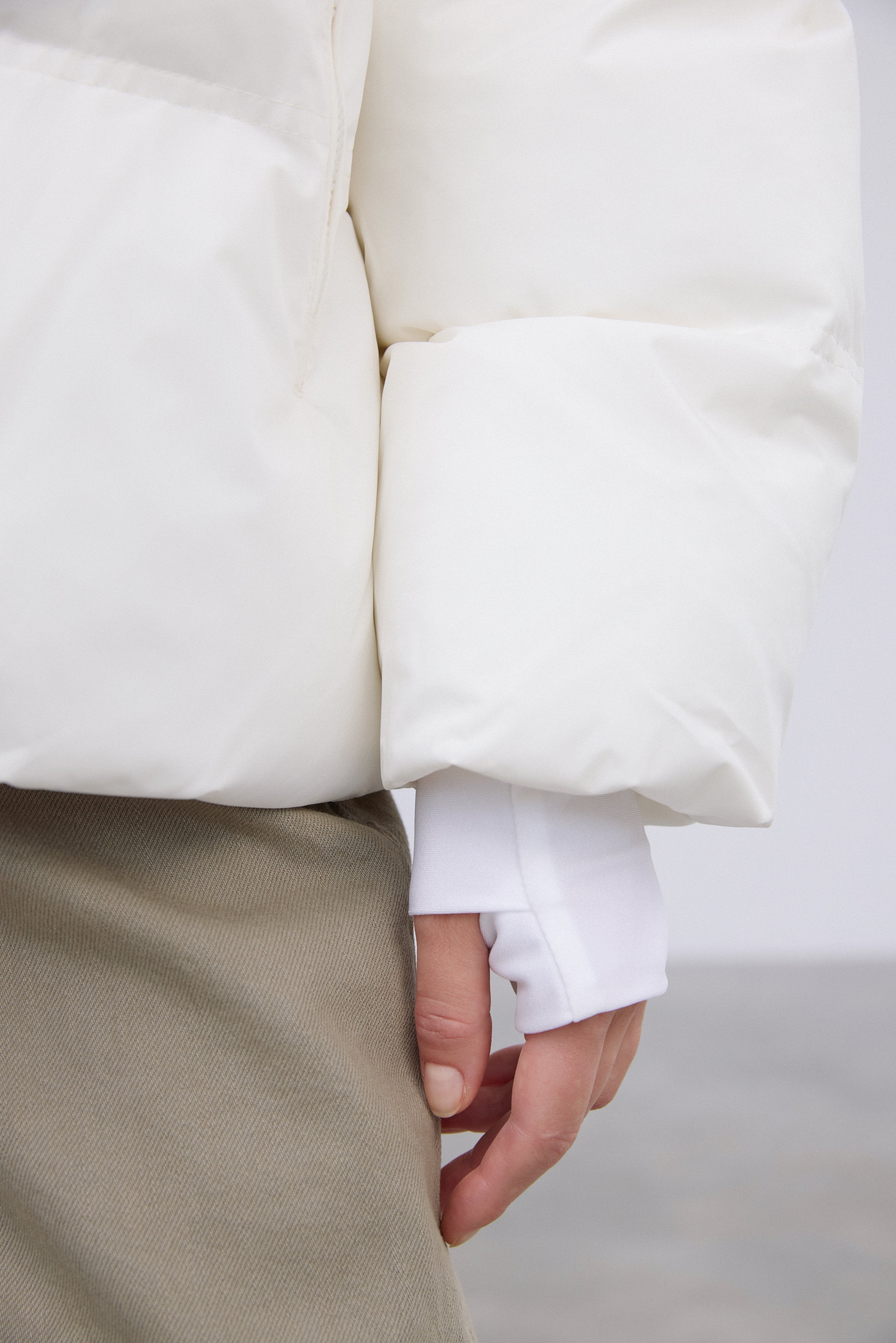 Warm women's jacket in a milky beige color with eco-friendly filling by Estro – details.
