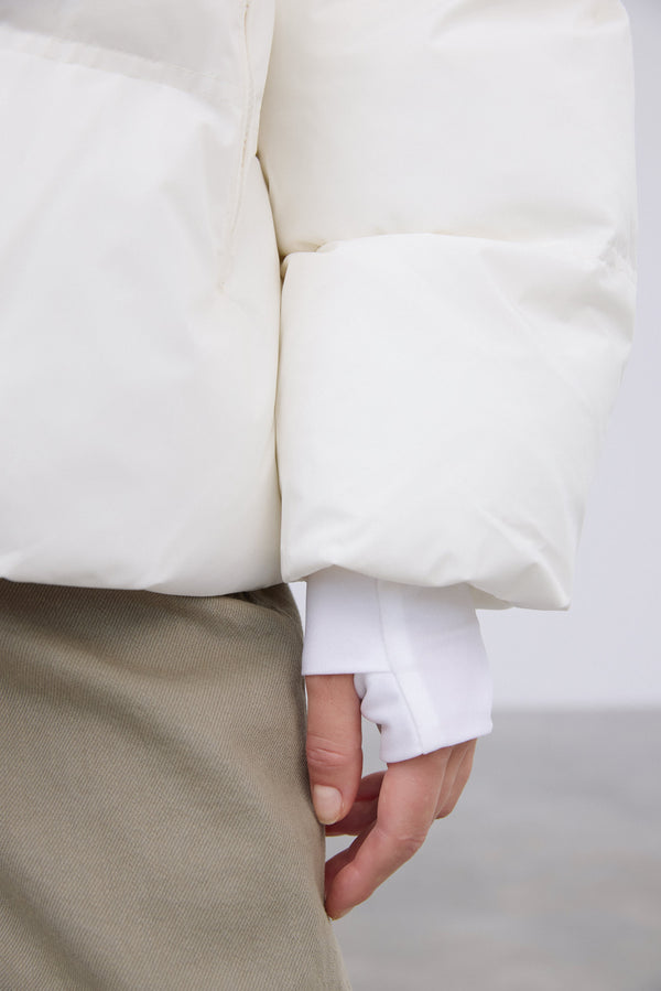 Warm women's jacket in a milky beige color with eco-friendly filling by Estro – details.