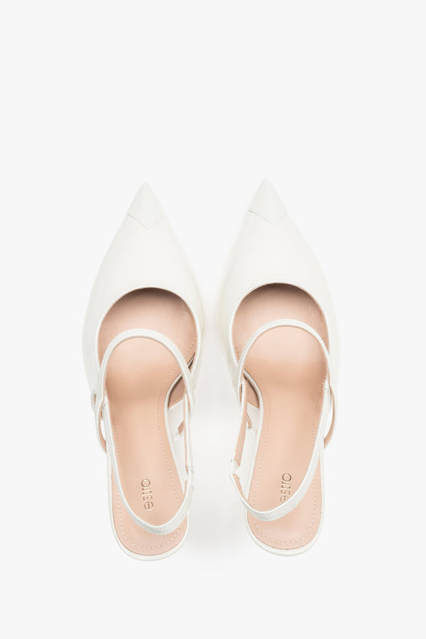 Close-up of the high-gloss milky beige patent leather and elegant strap detail.