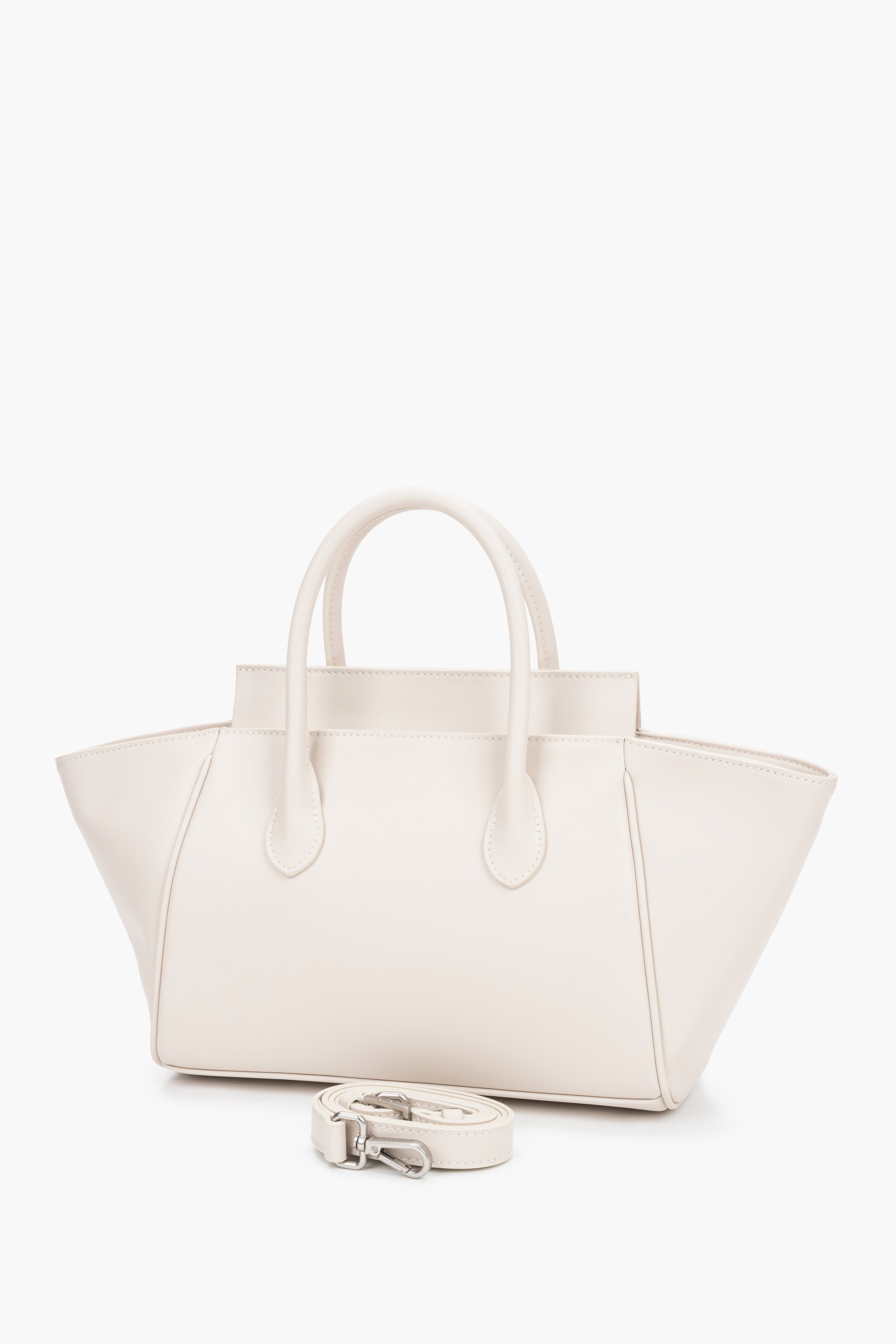 Milky beige women’s leather bag by Estro featuring a unique horizontal silhouette with wide trapeze-shaped sides and short handles.