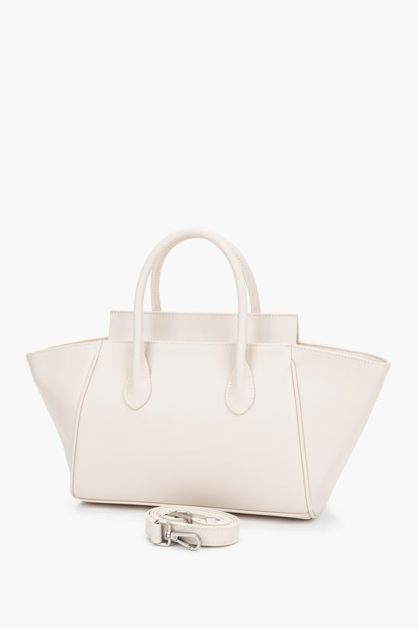 Milky beige women’s leather bag by Estro featuring a unique horizontal silhouette with wide trapeze-shaped sides and short handles.