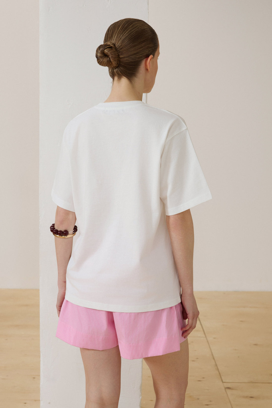 Women's milky white T-shirt with a boxy silhouette.
