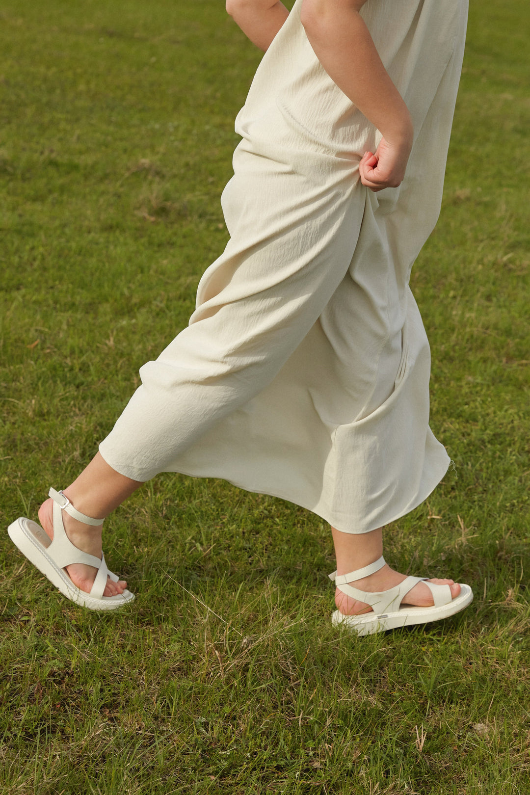 Milky white women’s sandals Estro, casual, on a thick sole – shoes on a model.