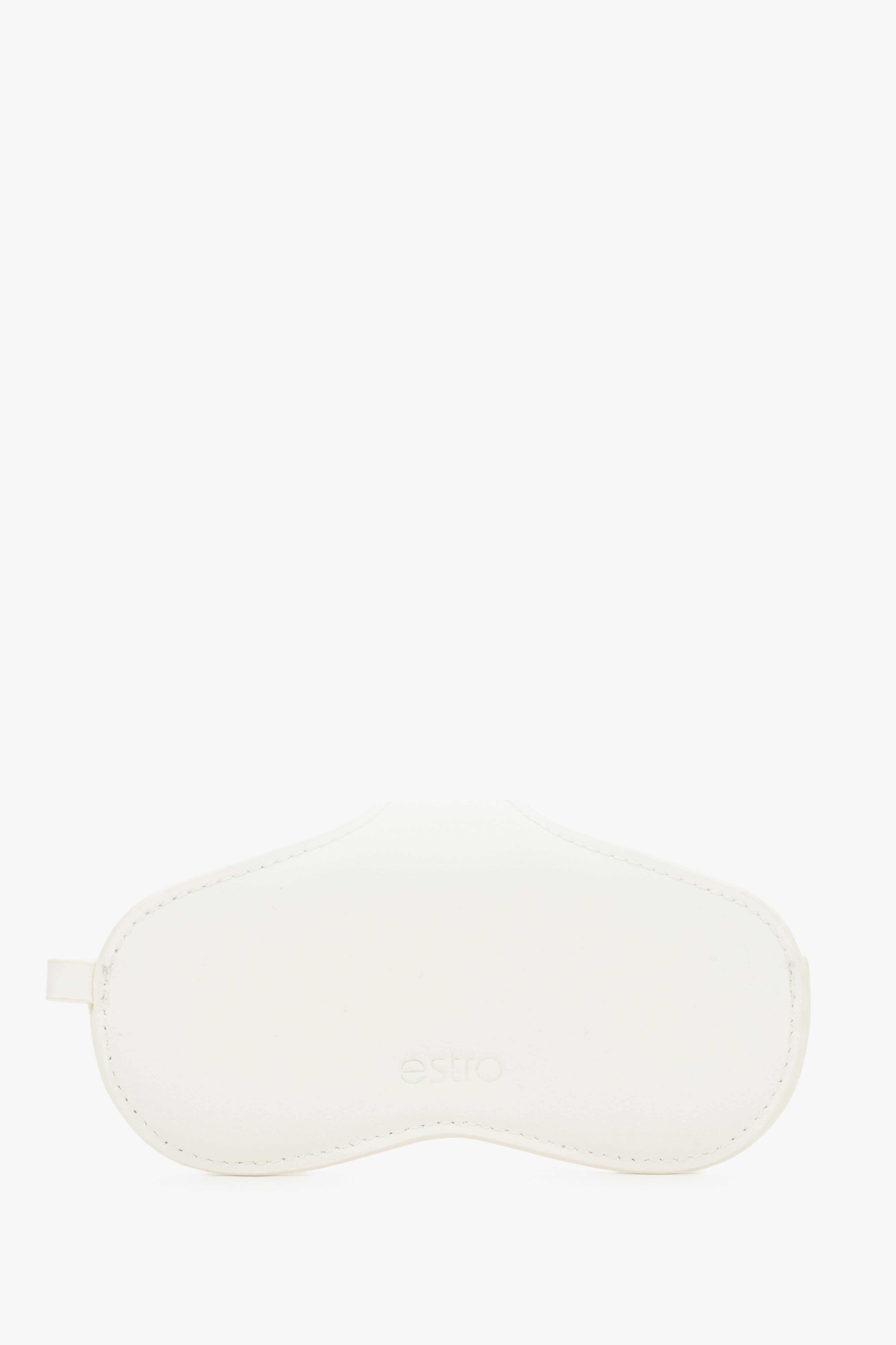 A side view emphasizing the slim, compact profile of the white case and its precise, tonal stitching.