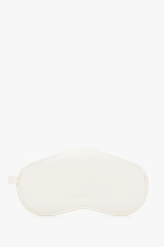 A side view emphasizing the slim, compact profile of the white case and its precise, tonal stitching.