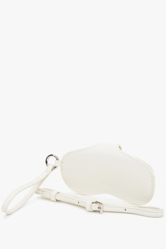 A close-up shot highlighting the adjustable leather strap and the cool brilliance of the silver-tone metal hardware against the creamy leather.