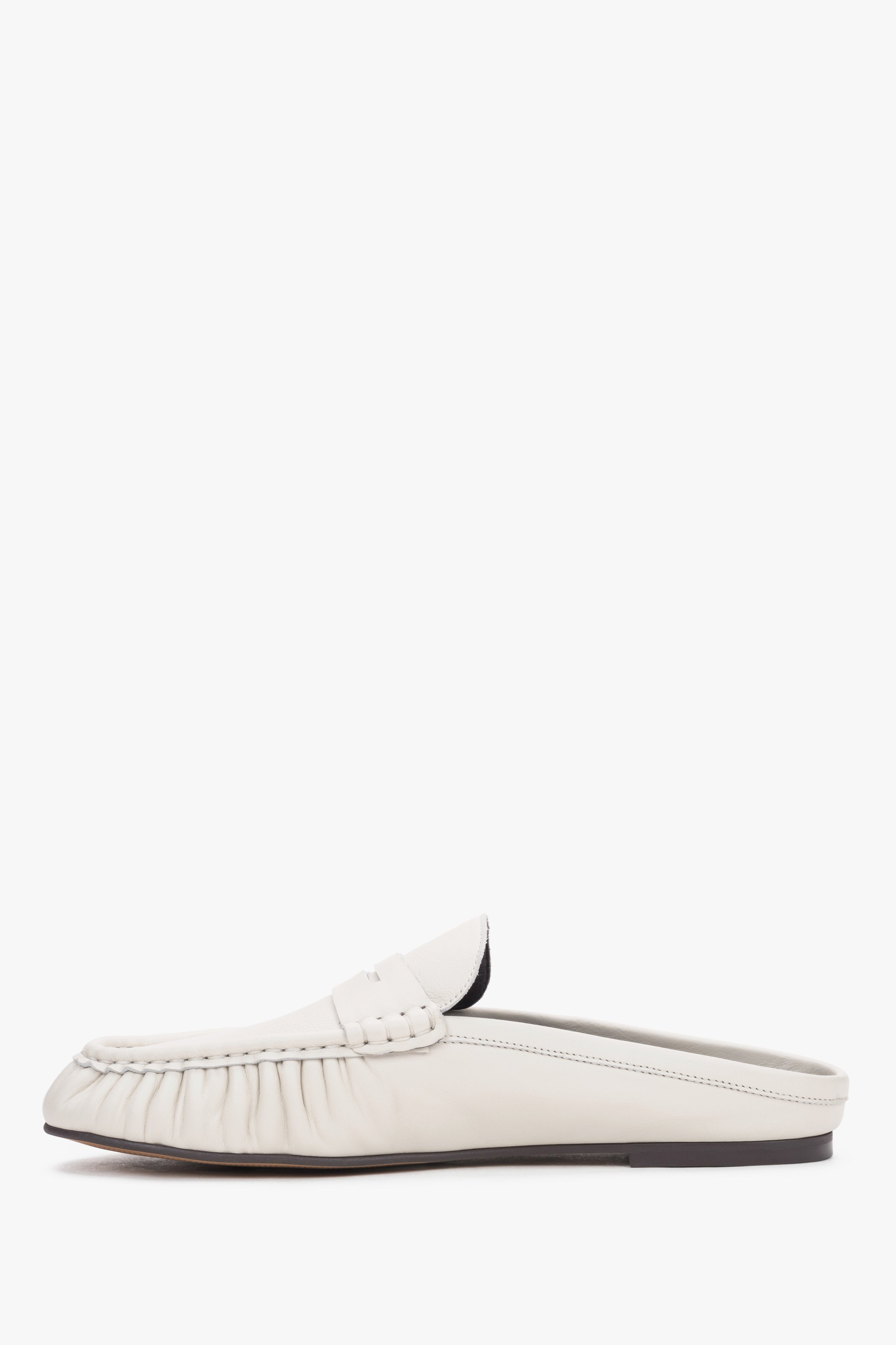 Elegant women’s slip-on mules showcasing a low, stable heel and a perfectly contoured arch line.