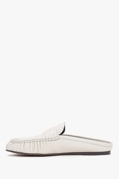 Elegant women’s slip-on mules showcasing a low, stable heel and a perfectly contoured arch line.