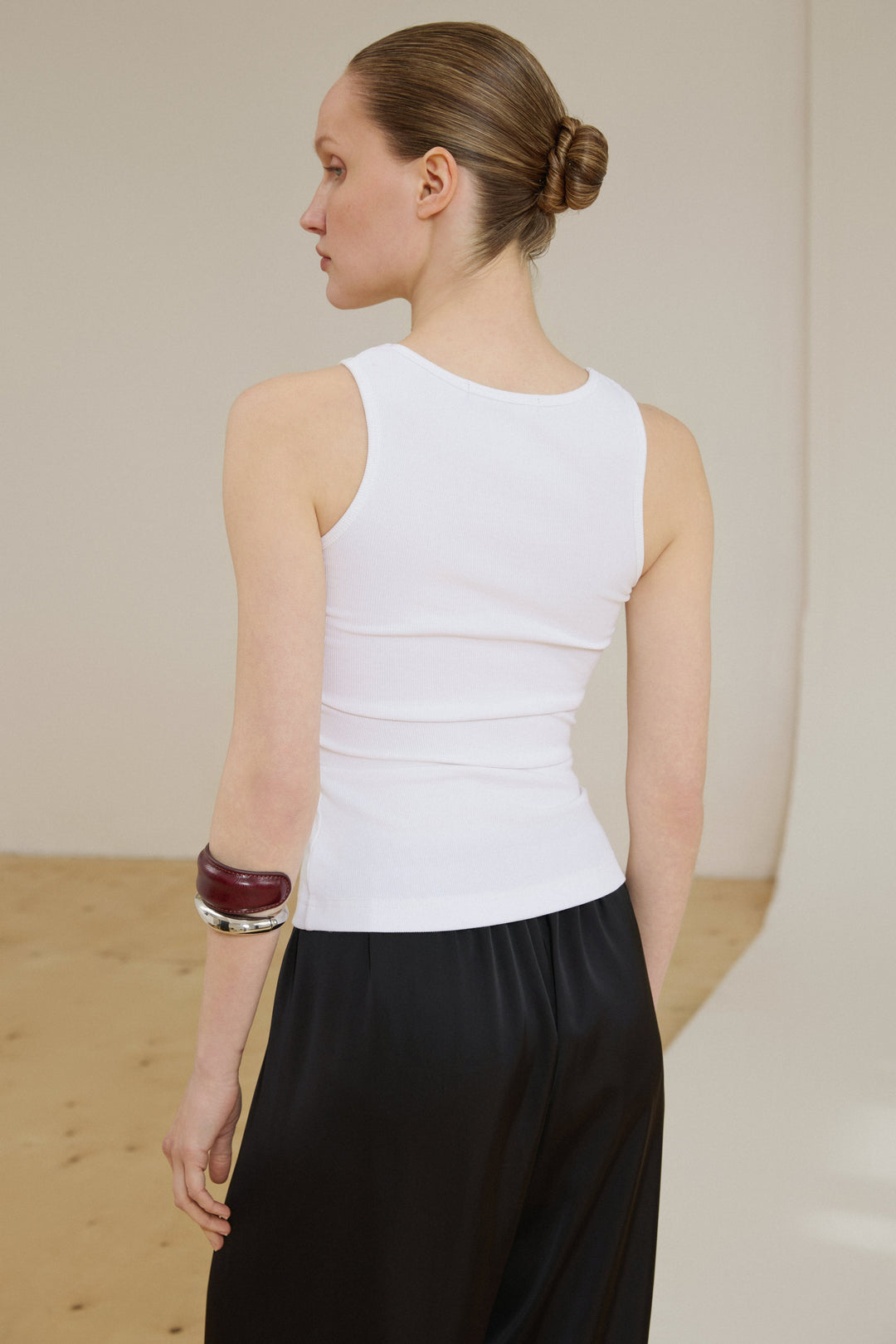 Back of women’s milky white ribbed cotton top.