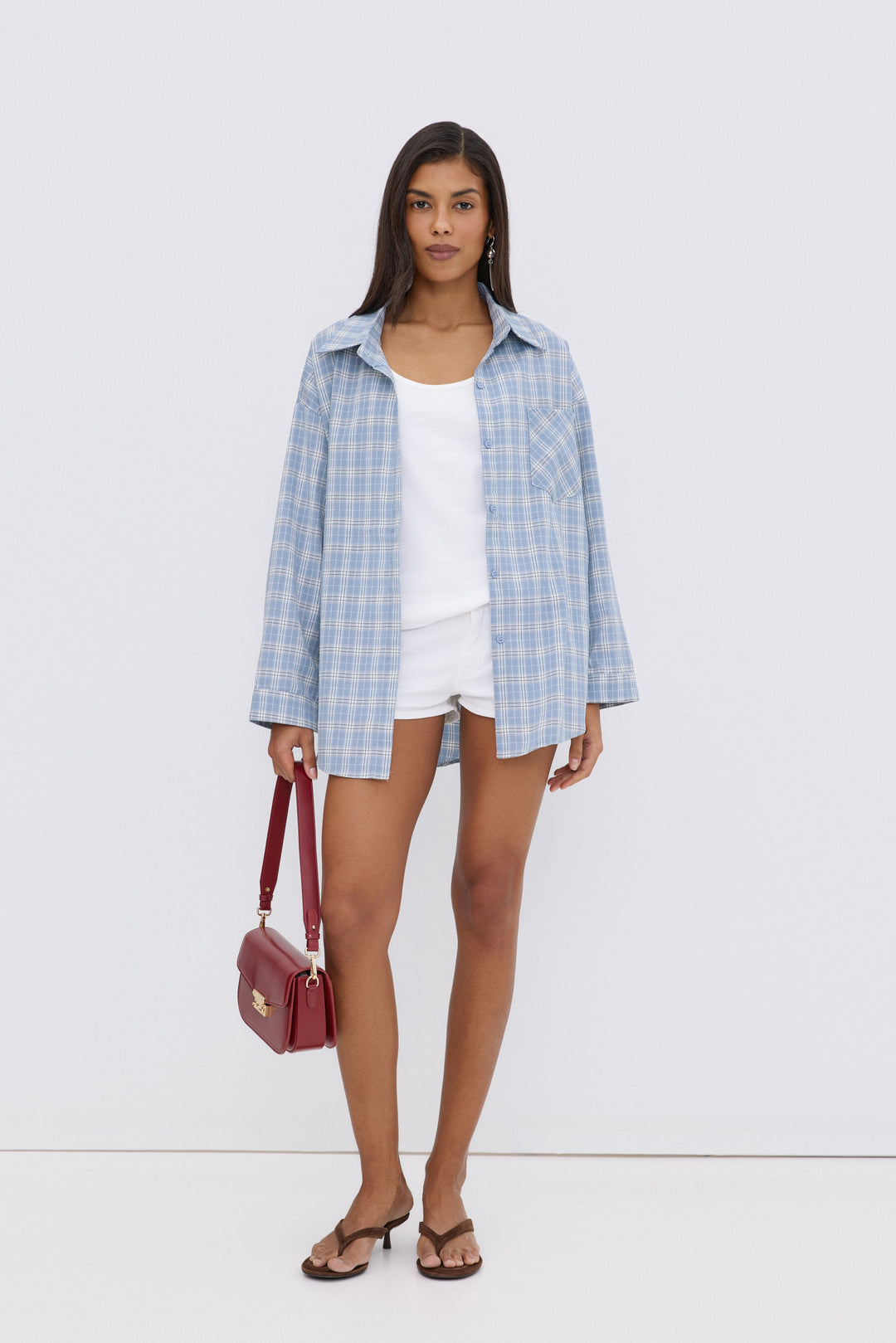 Women's oversized button-up shirt in blue and white plaid.