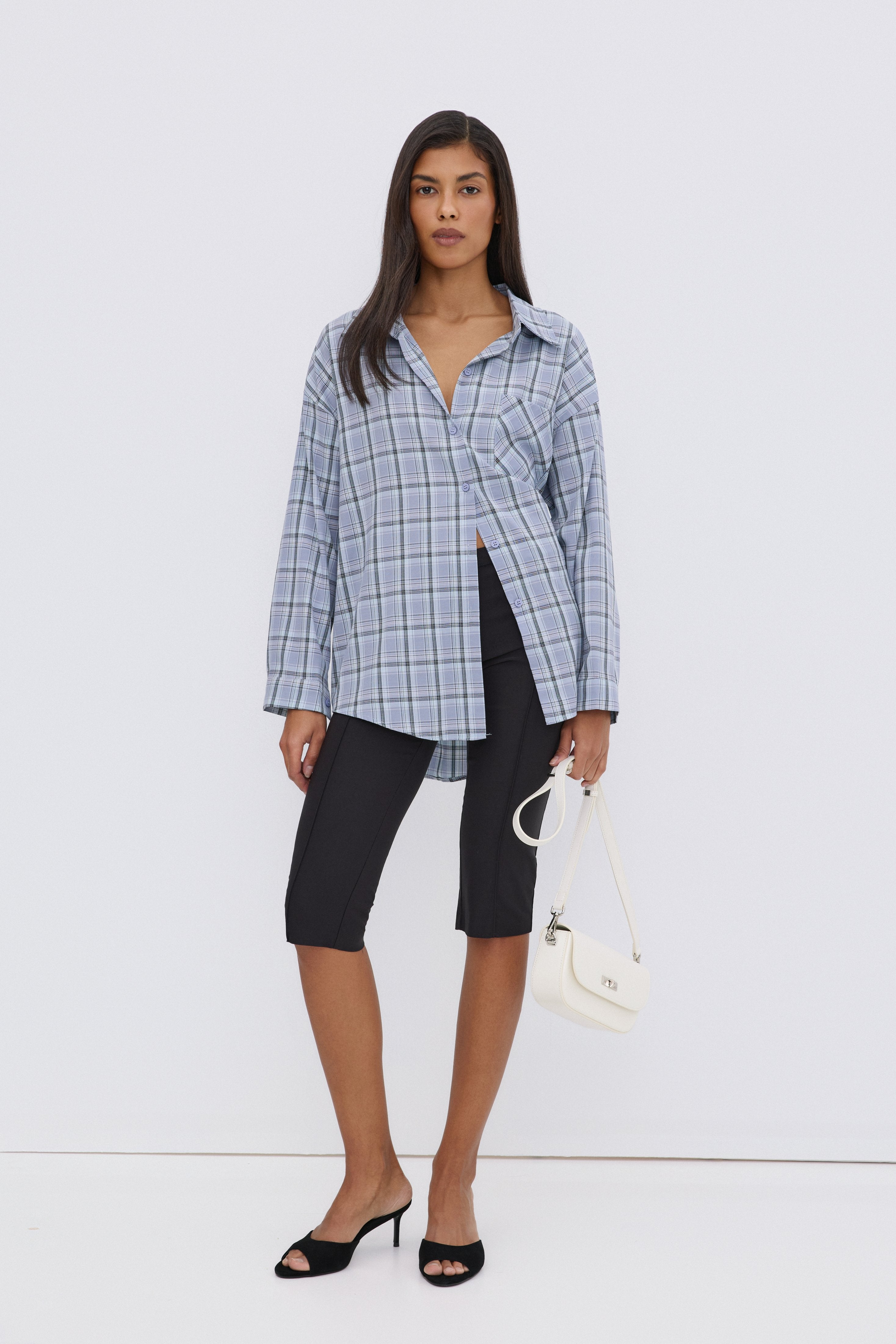 Blue women's Estro shirt, featuring an oversized fit, checkered pattern, and button-up closure.
