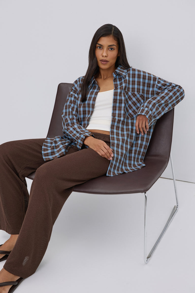 Blue and brown women's Estro shirt, featuring an oversized fit, plaid pattern, and button-up closure.
