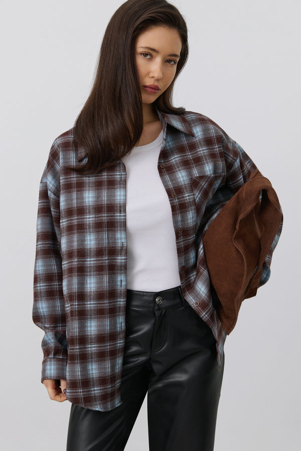 Women's oversized button-up shirt in burgundy and blue plaid.