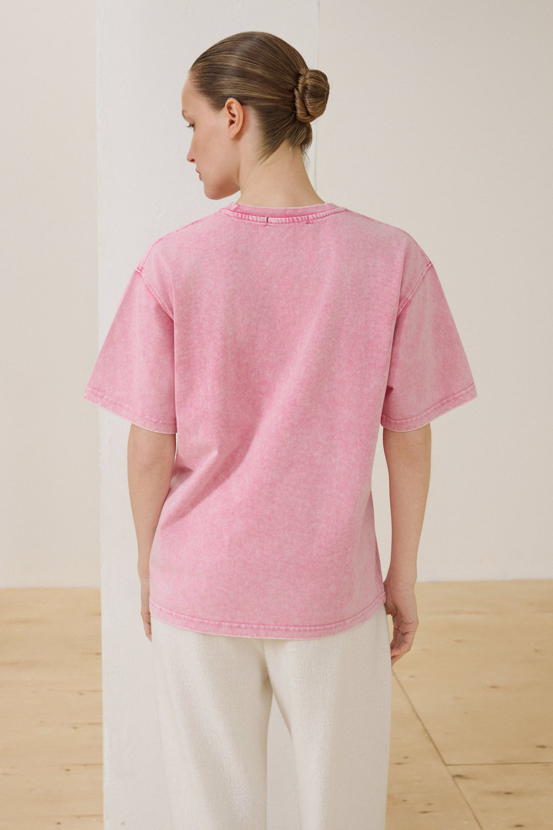 Back of women's pink washed-effect cotton T-shirt.
