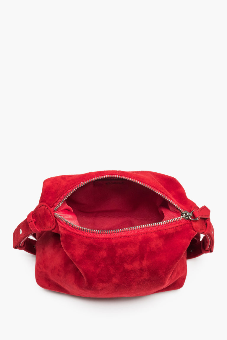 A top view of the open zippered compartment, showcasing the dark lining and two functional pockets for small items.