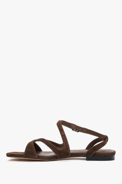 Side view of women’s saddle brown flat sandals.
