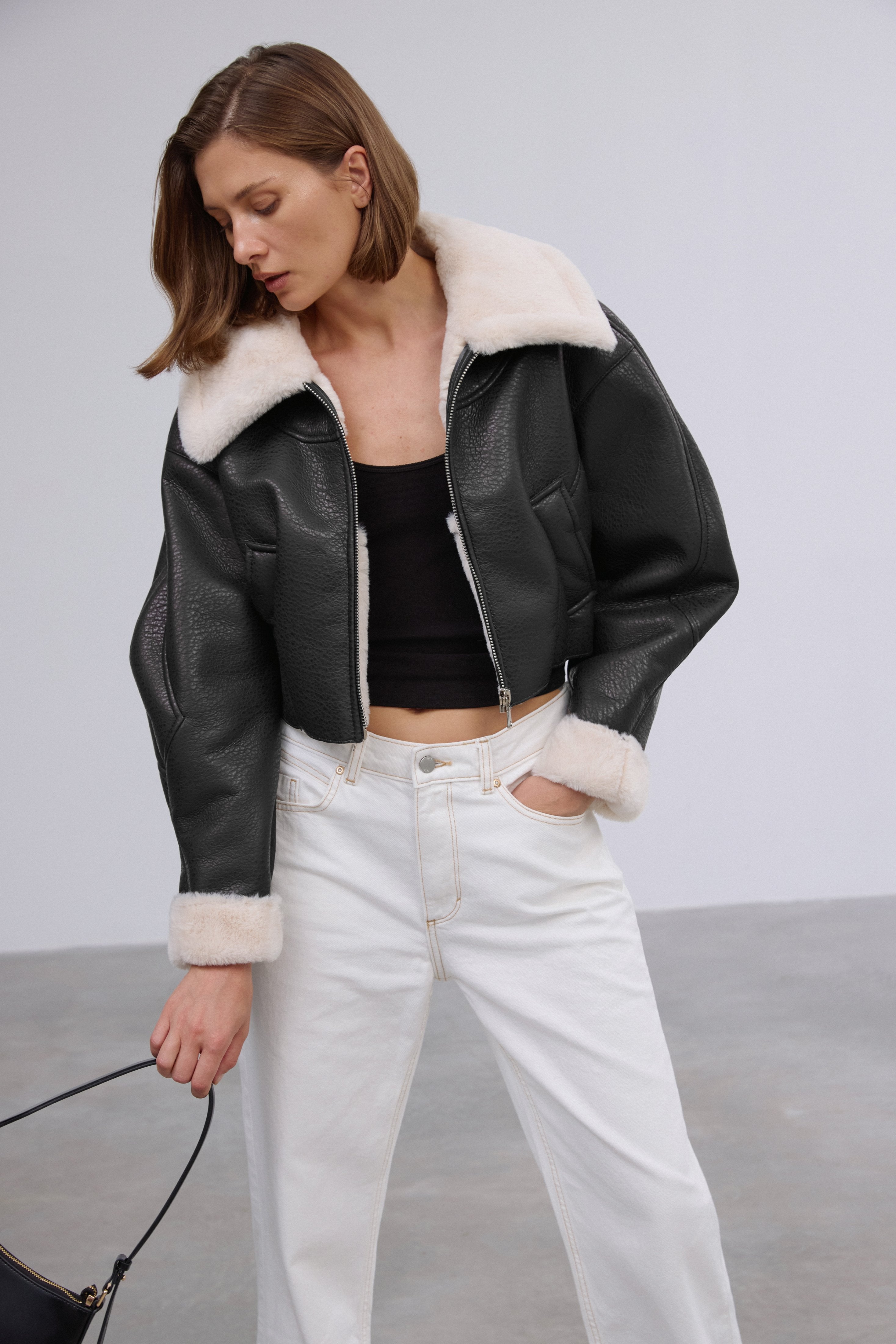 Short women's black shearling-style jacket, Estro brand.