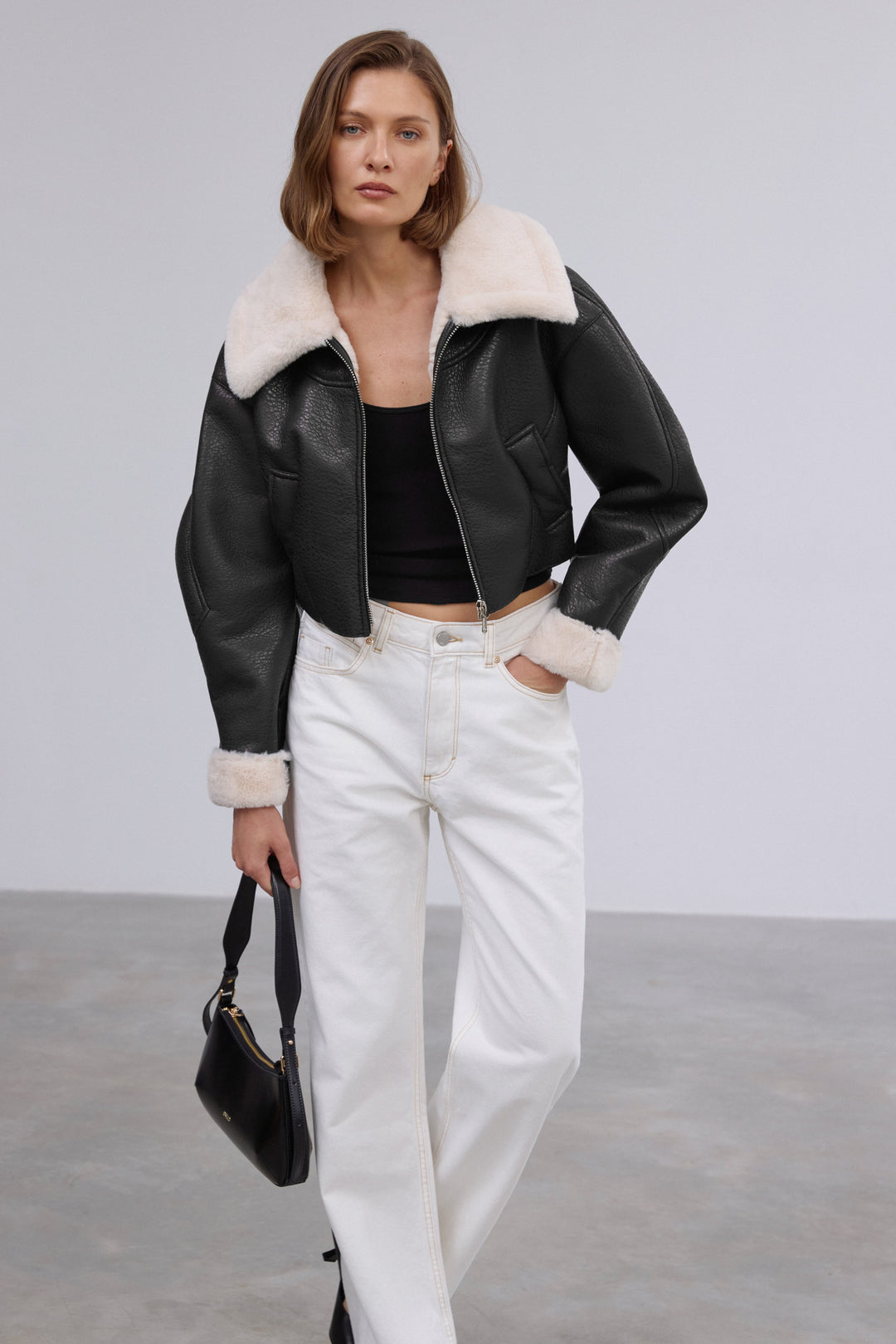 Women's black faux leather shearling jacket with soft fur trim by Estro.