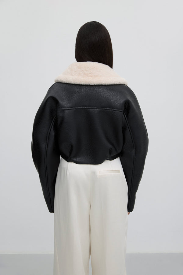Short black jacket with faux fur collar – back view.